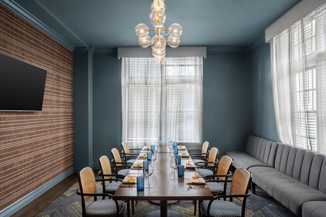 Long table, chairs and chandelier in private 