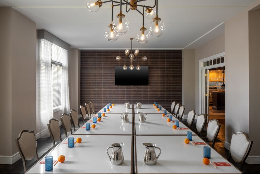 Long table, chairs and chandelier at Fenway Hotel 