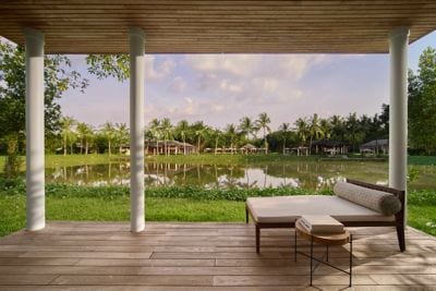 A serene lakeside balcony for peaceful lounging.