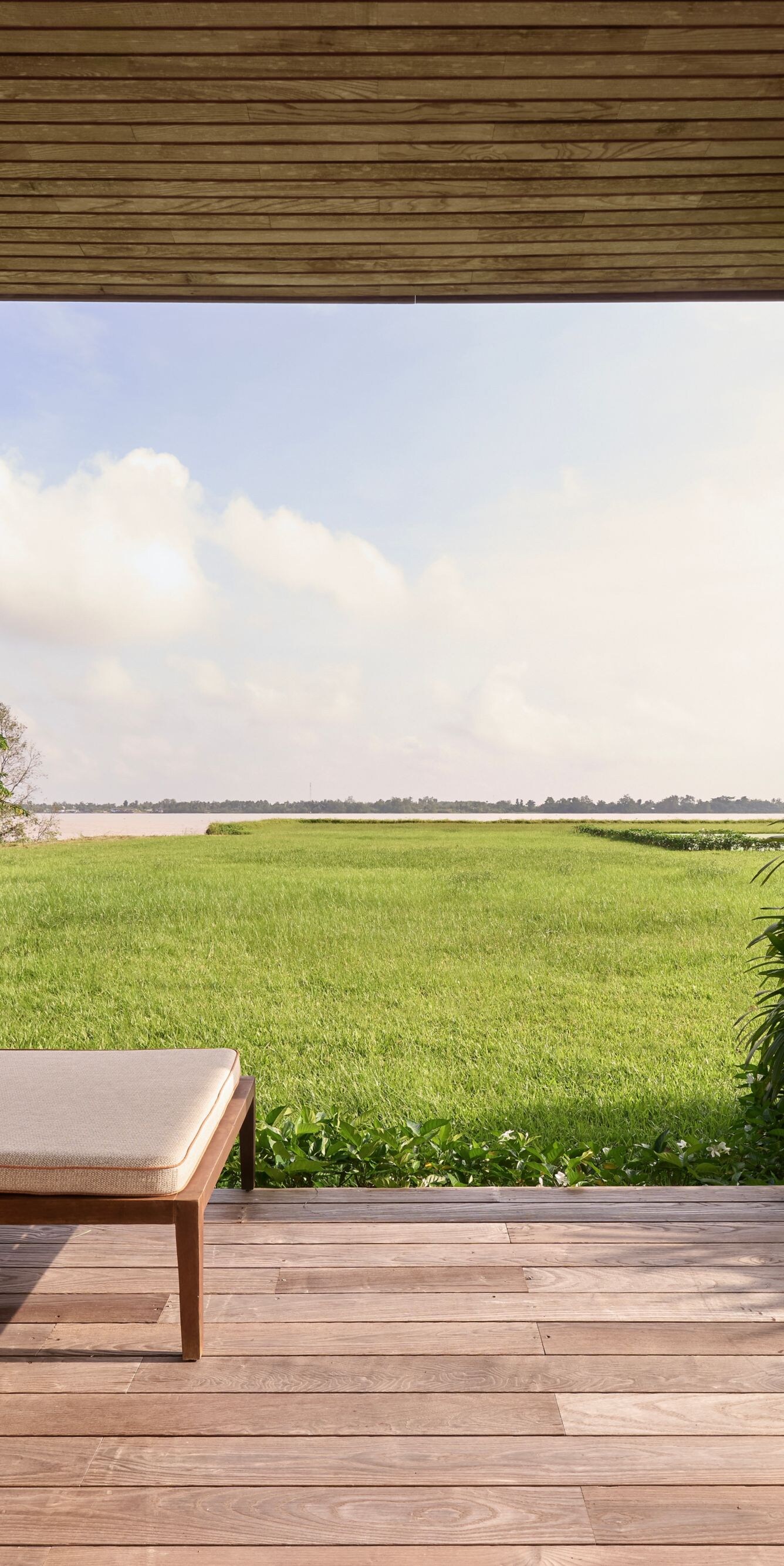 A peaceful balcony with open, breezy water views.