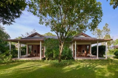 Nature-framed bungalow with open verandas.