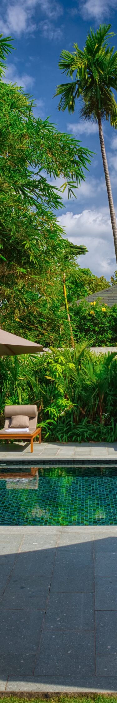 Private villa pool with sun loungers and umbrellas