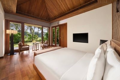 A king bungalow surrounded by tropical greens.