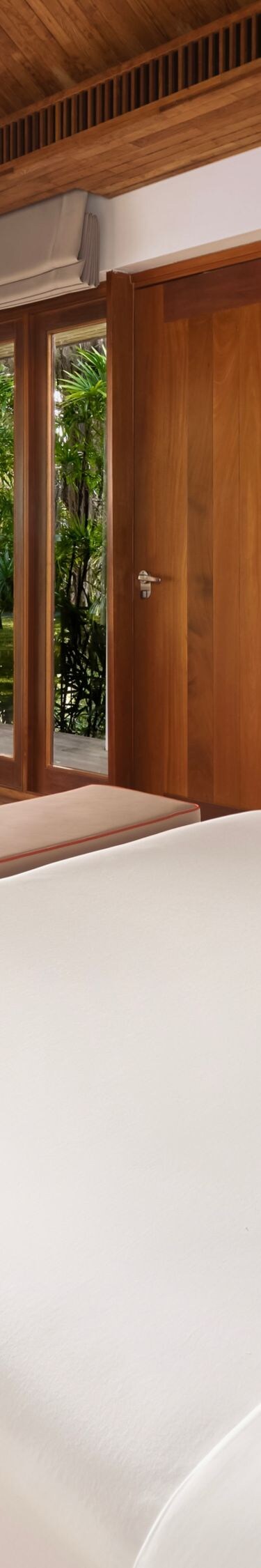 A king bungalow surrounded by tropical greens.