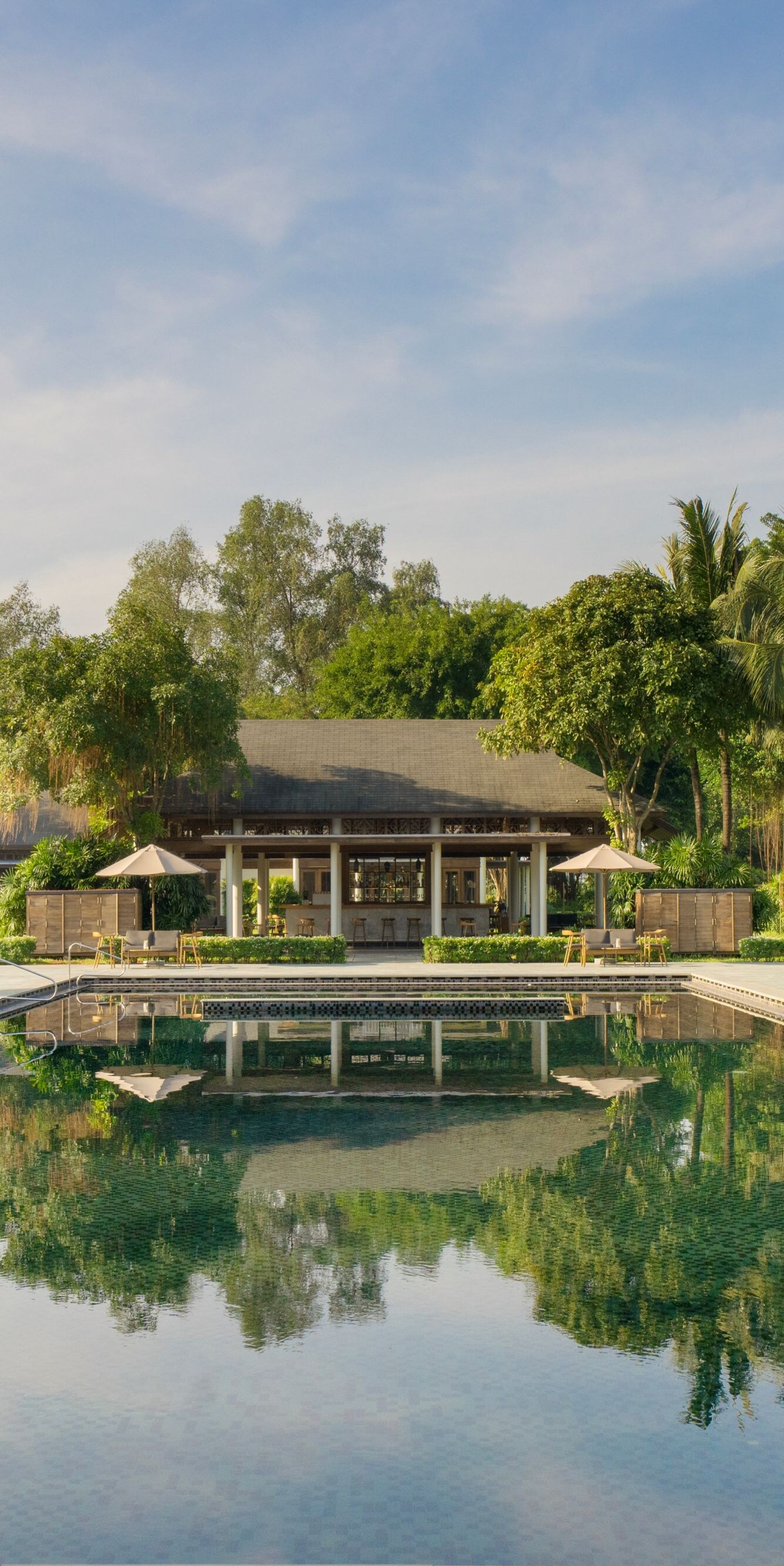 A serene main pool embraced by lush greenery.
