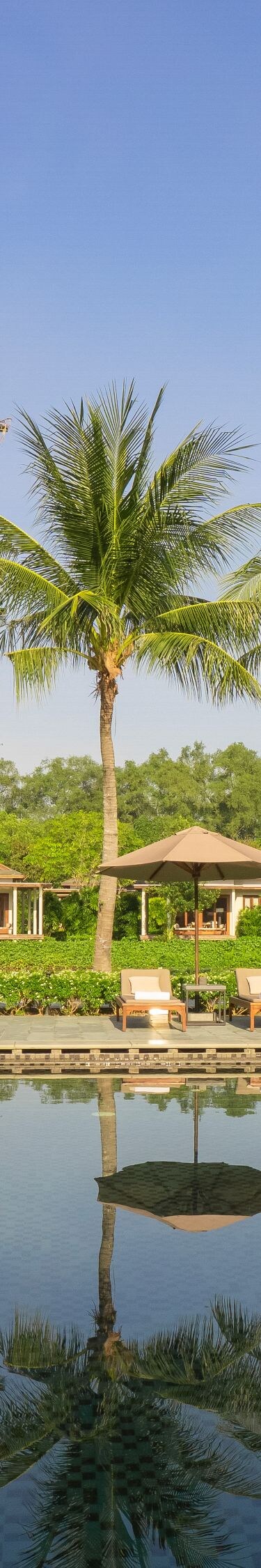 Tropical cabanas by a tranquil pool.
