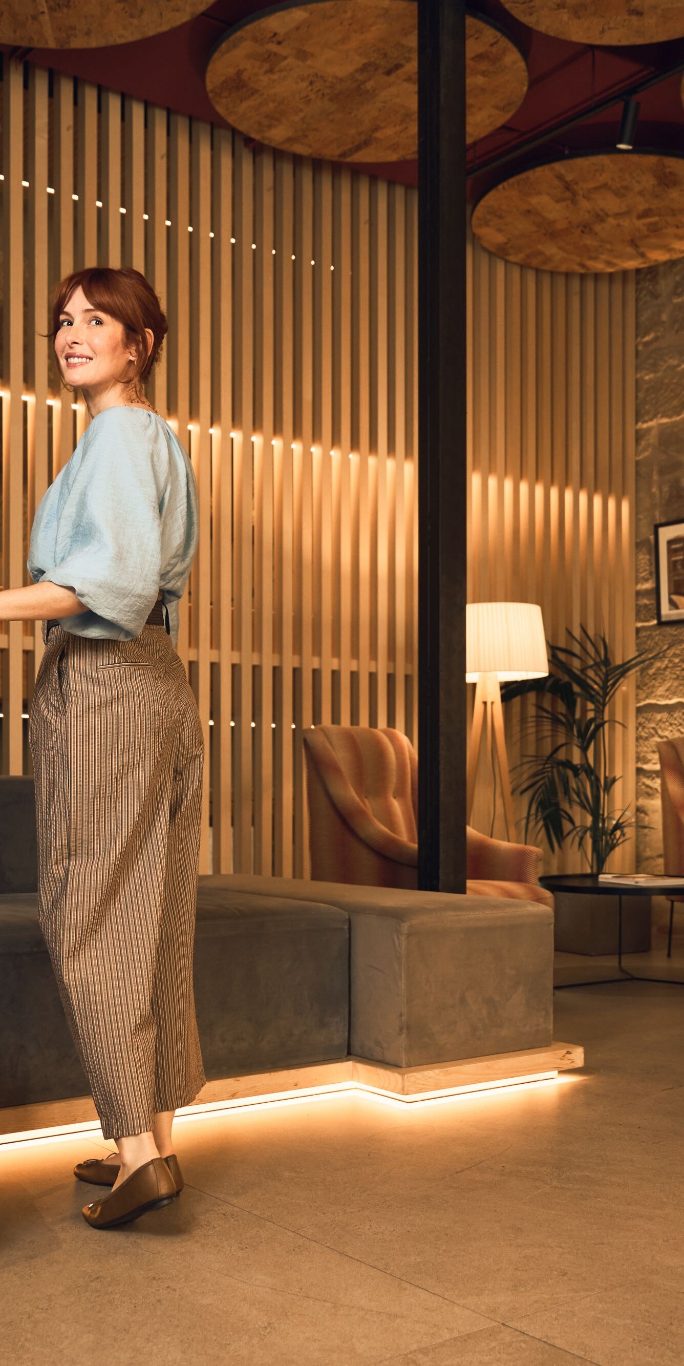 Woman with luggage in lobby 
