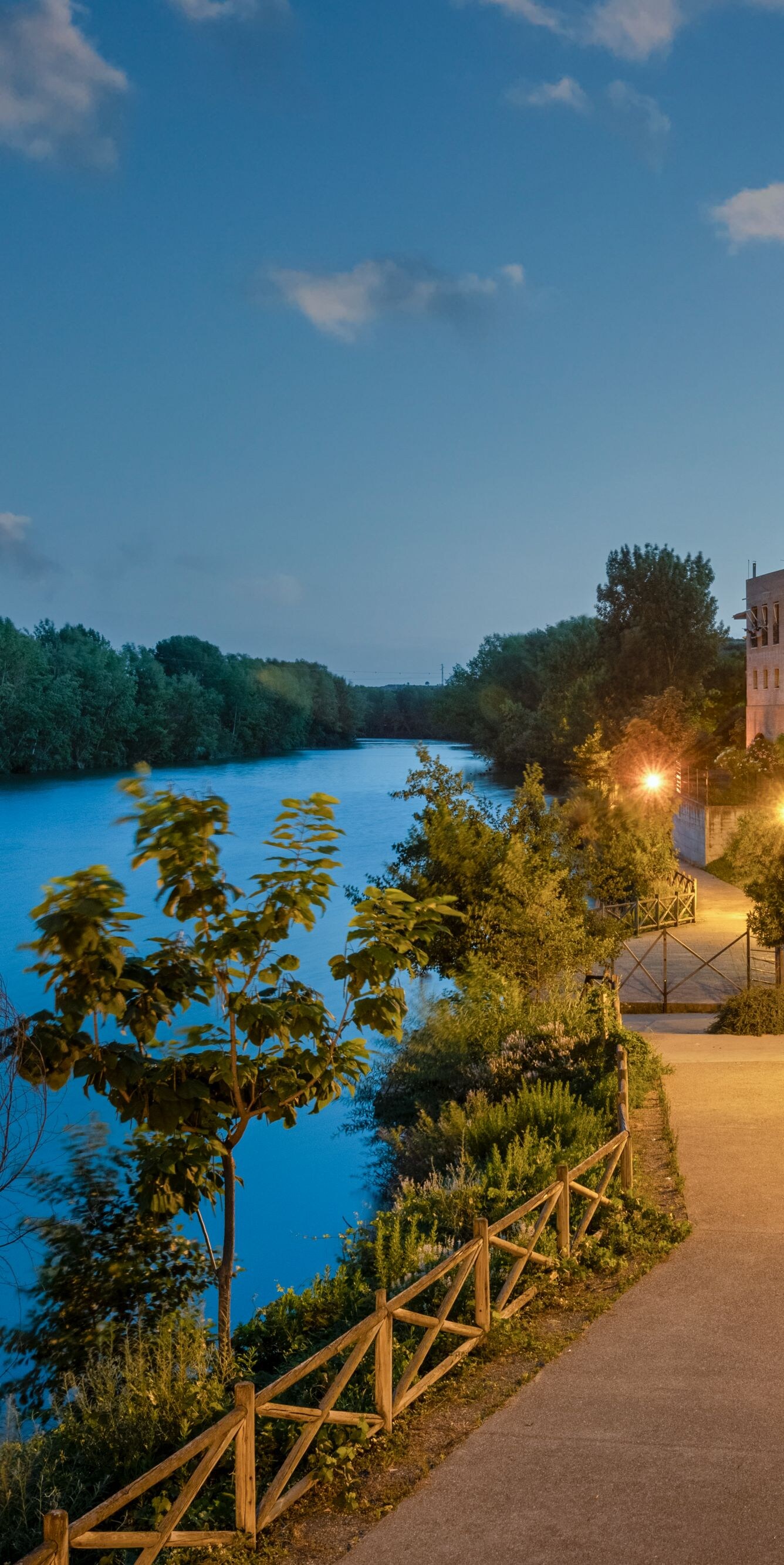 Riverside terrace with seating at dusk