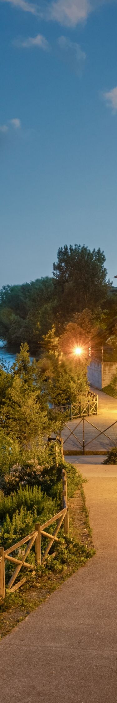 Riverside terrace with seating at dusk