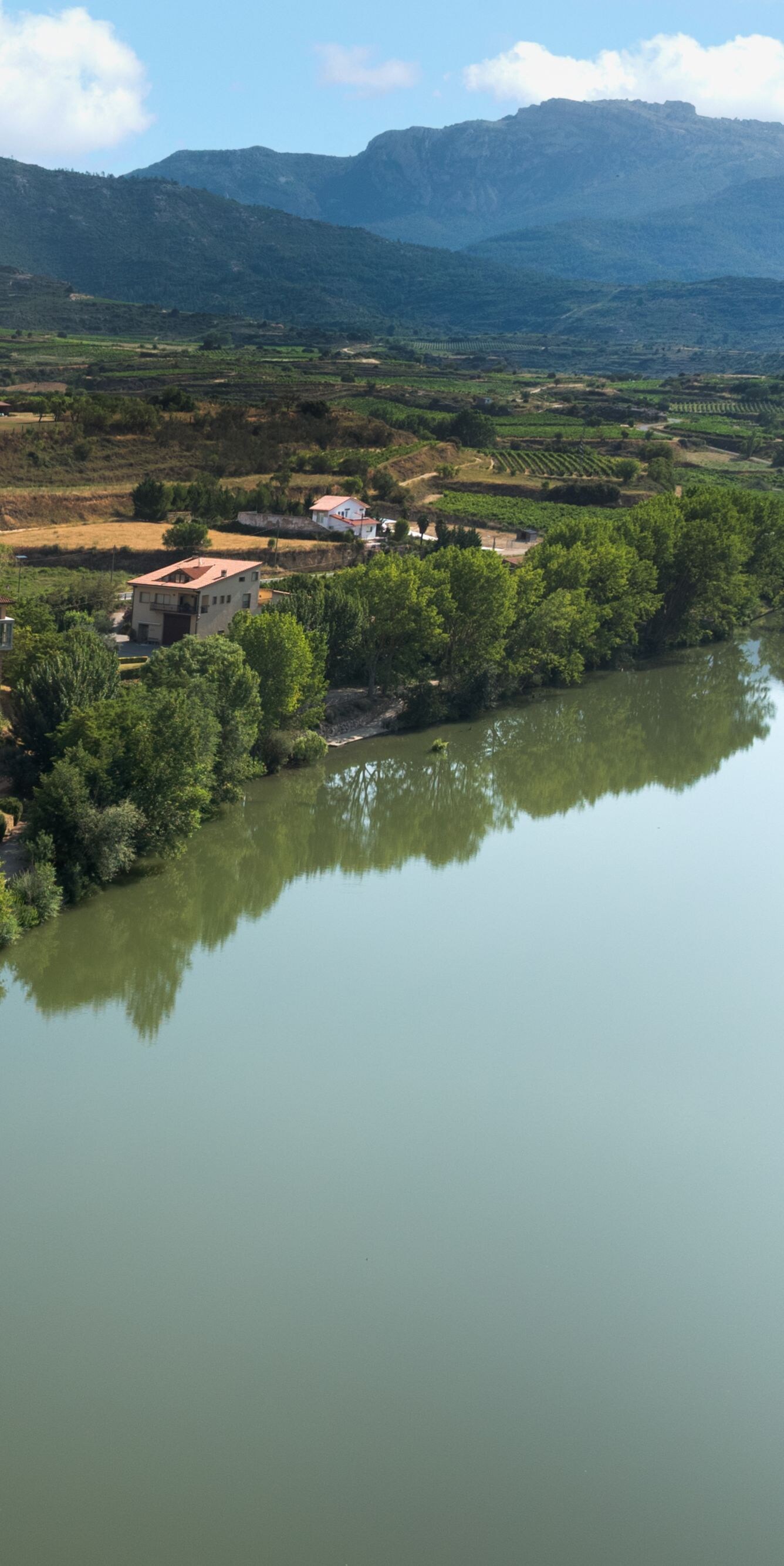 Riverfront view with village and mountains