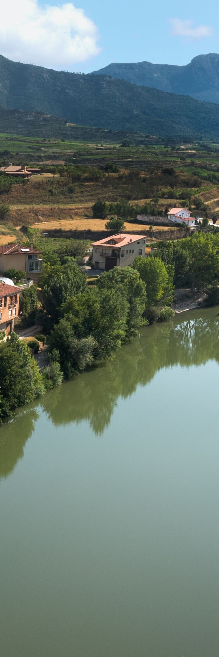 Riverfront view with village and mountains