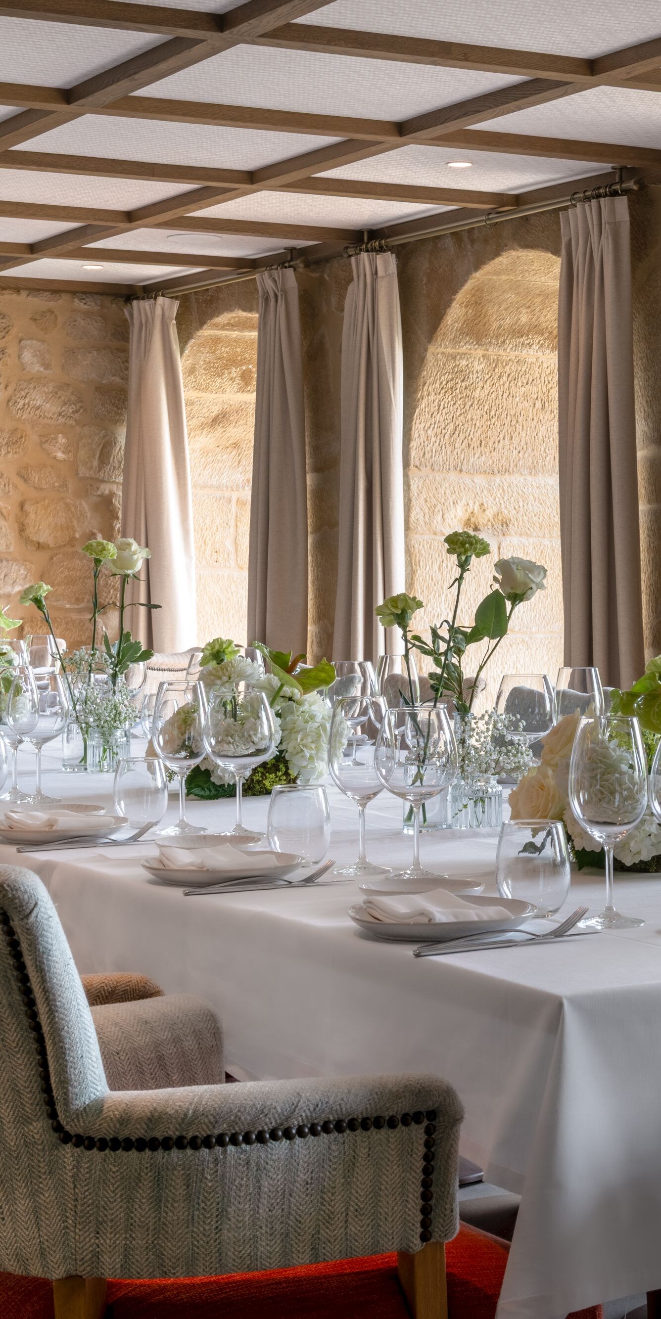 Dining room with stone walls and floral decor