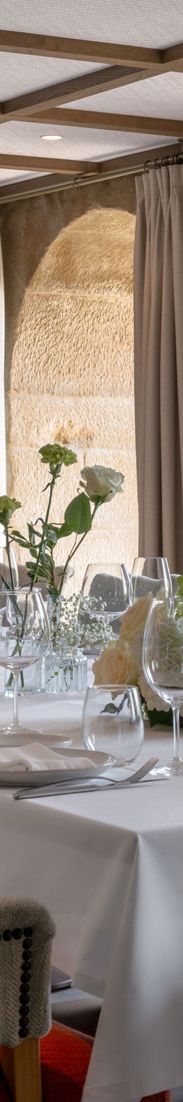 Dining room with stone walls and floral decor