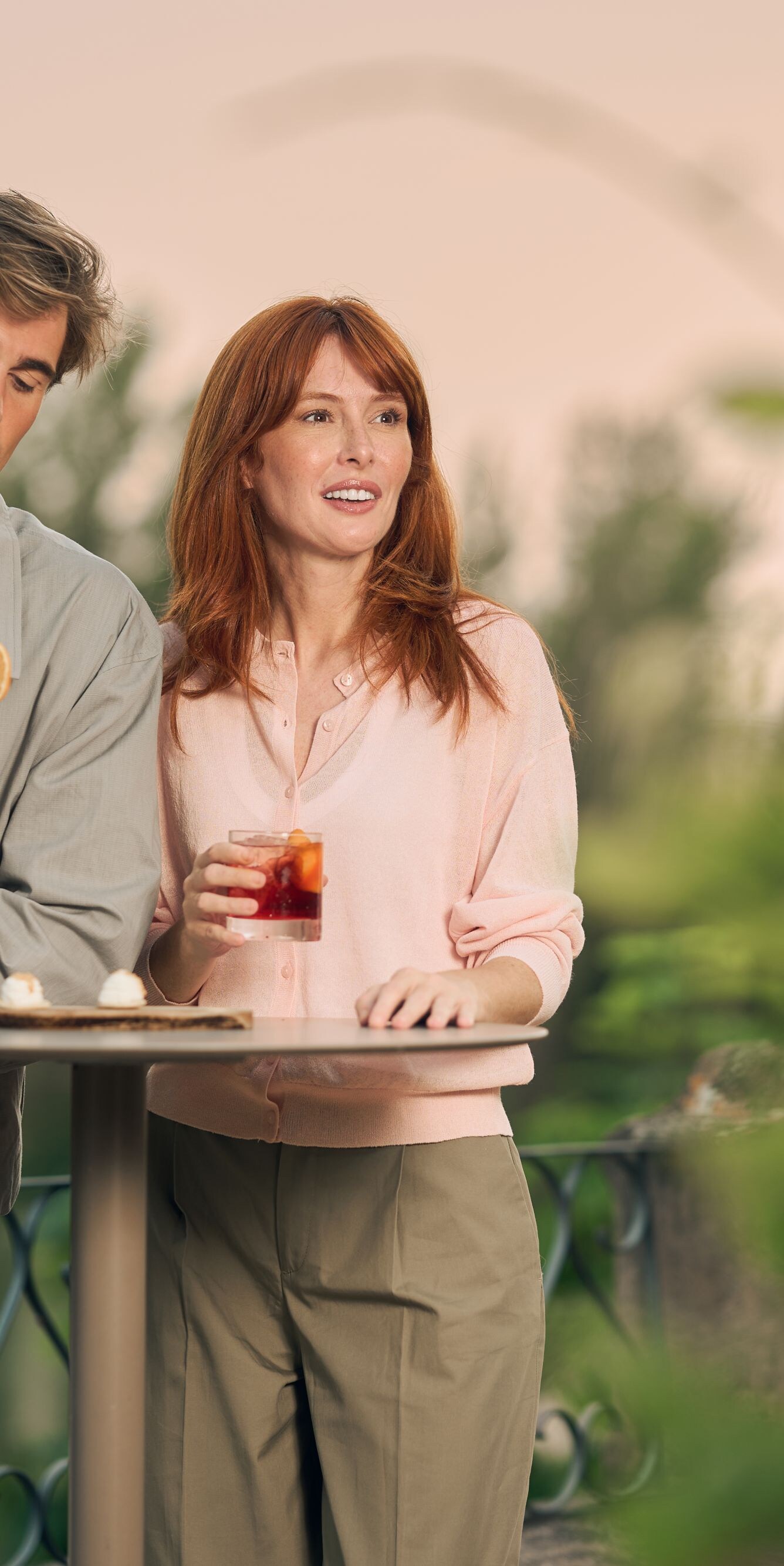 Couple on terrace enjoying cocktails 