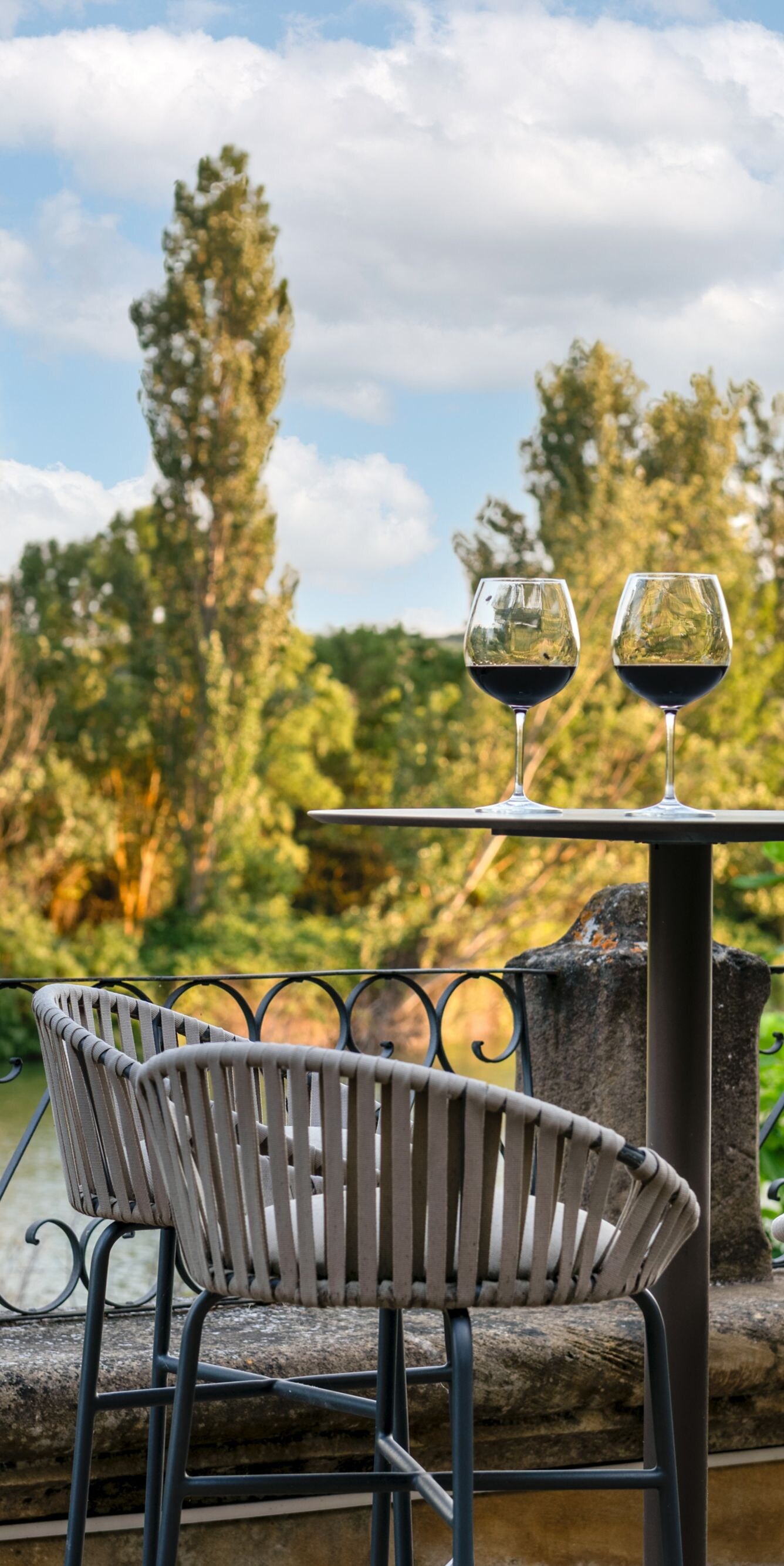 Outdoor terrace with wine and river view