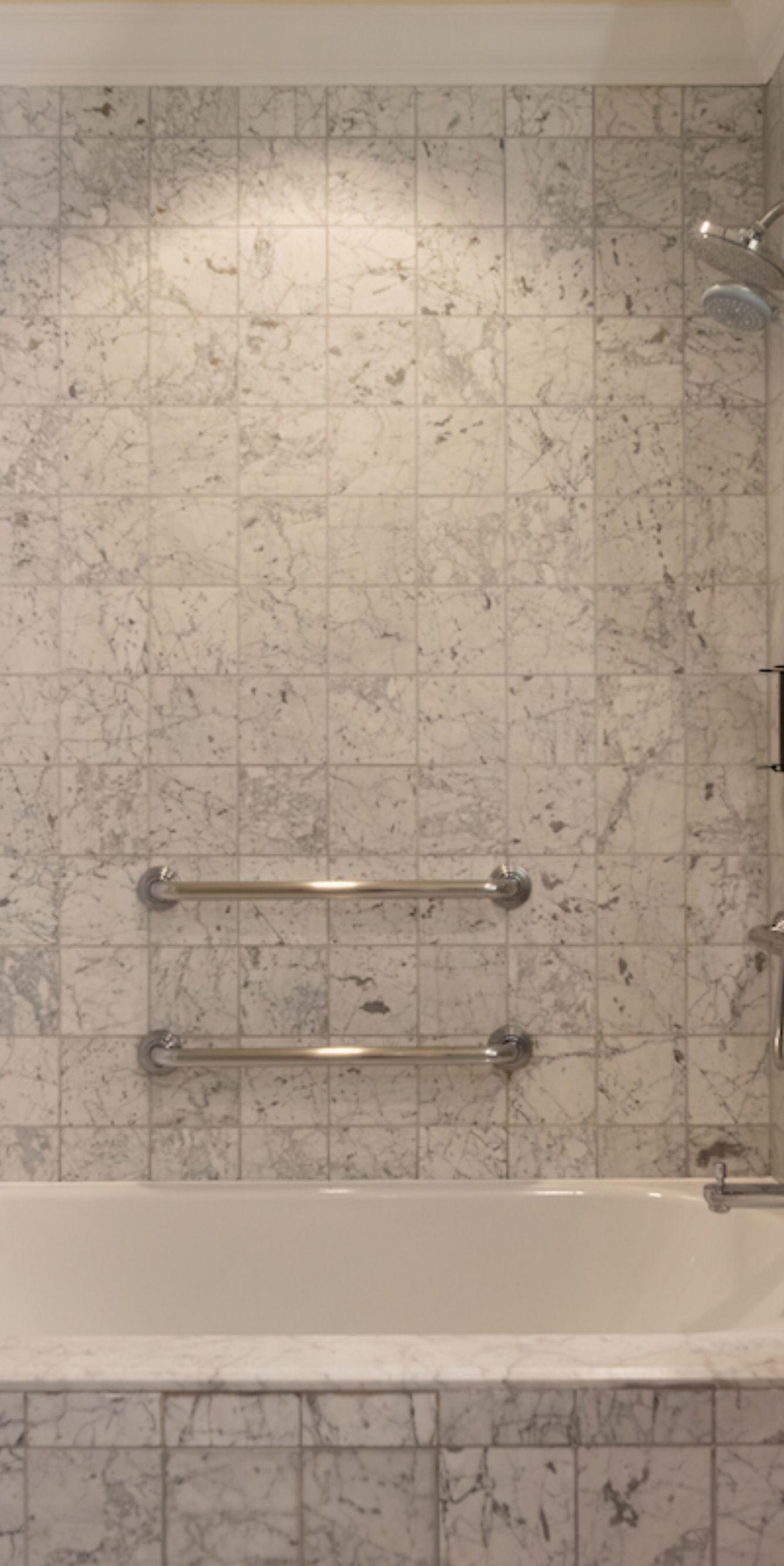 Accessible bathroom with tub, grab bars, vanity