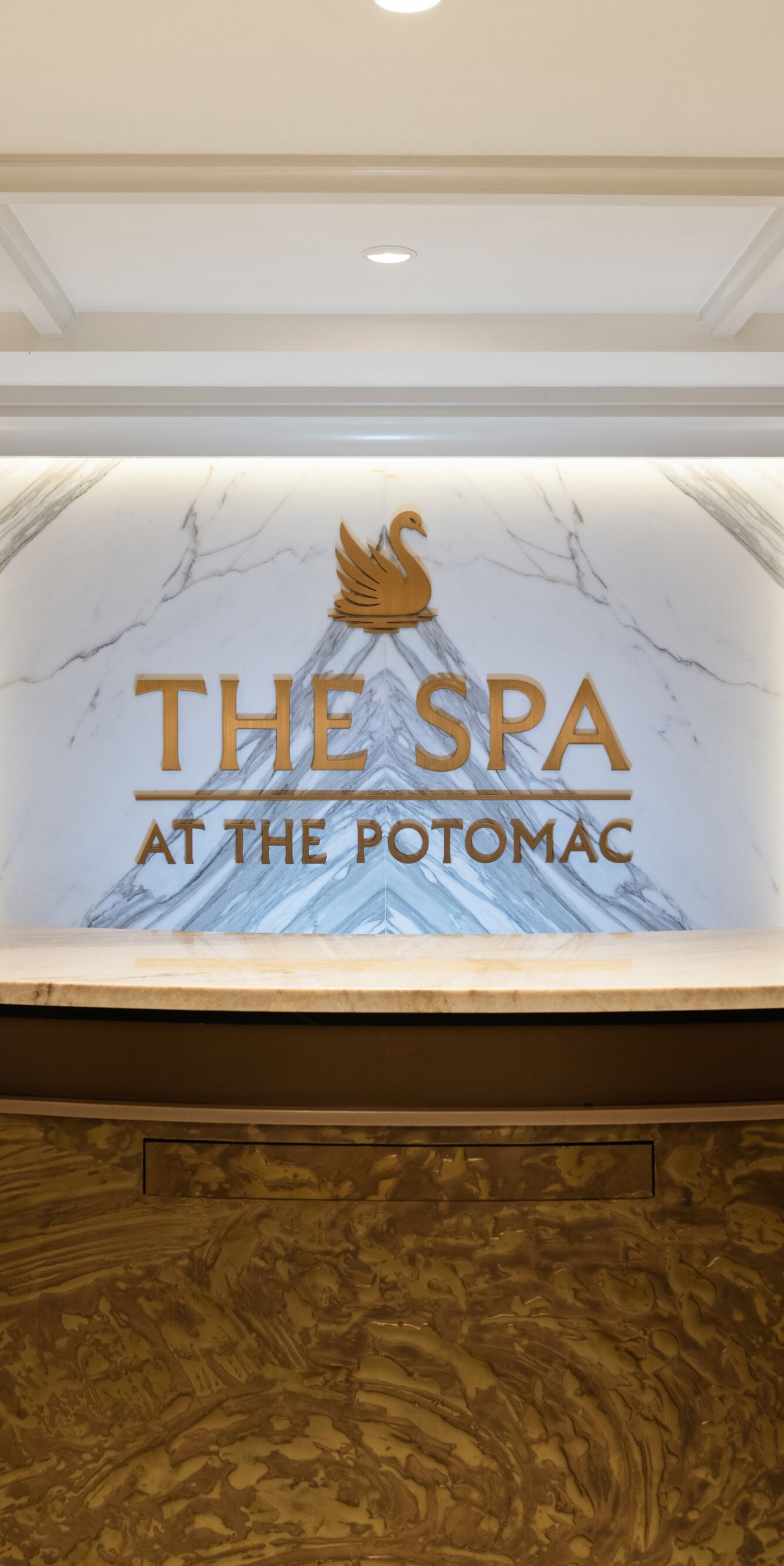 Spa reception desk with marble backdrop
