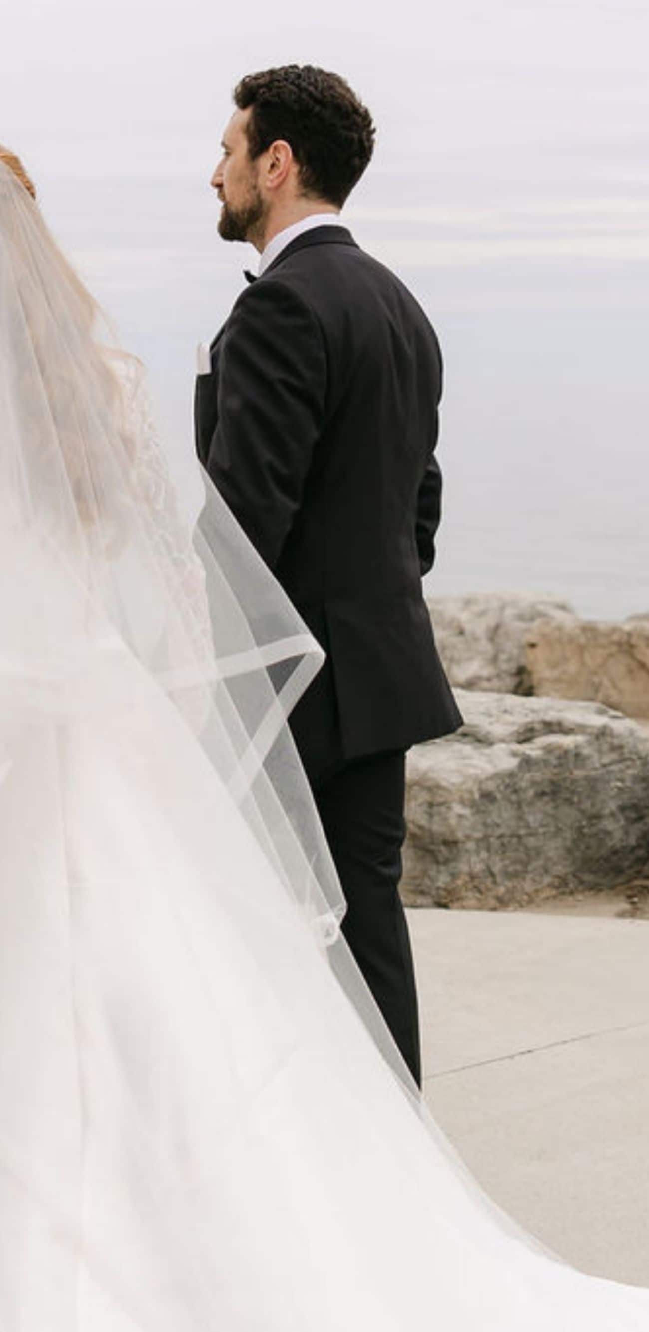Bride and groom with bouquet by waterfront
