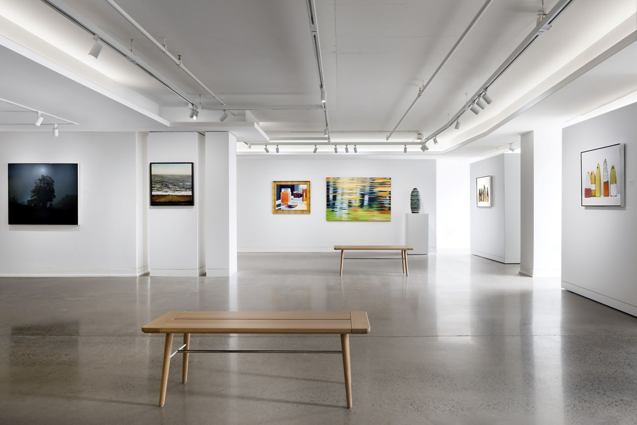 Light filled art gallery with wooden benches