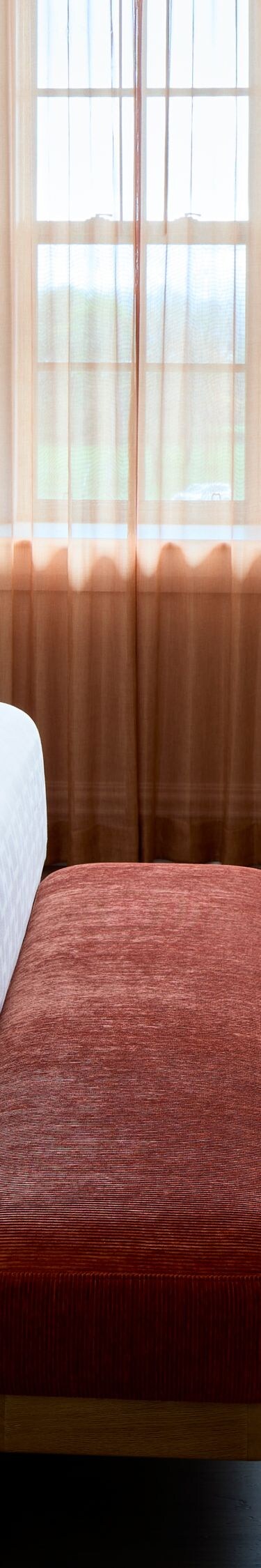 King Suite Room with bench, dresser, TV