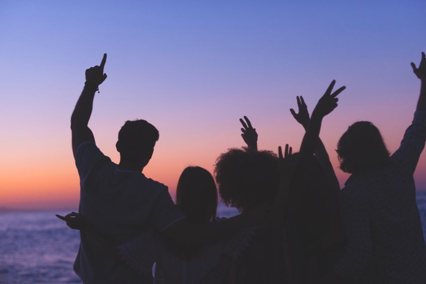 a group of people partying during sunset