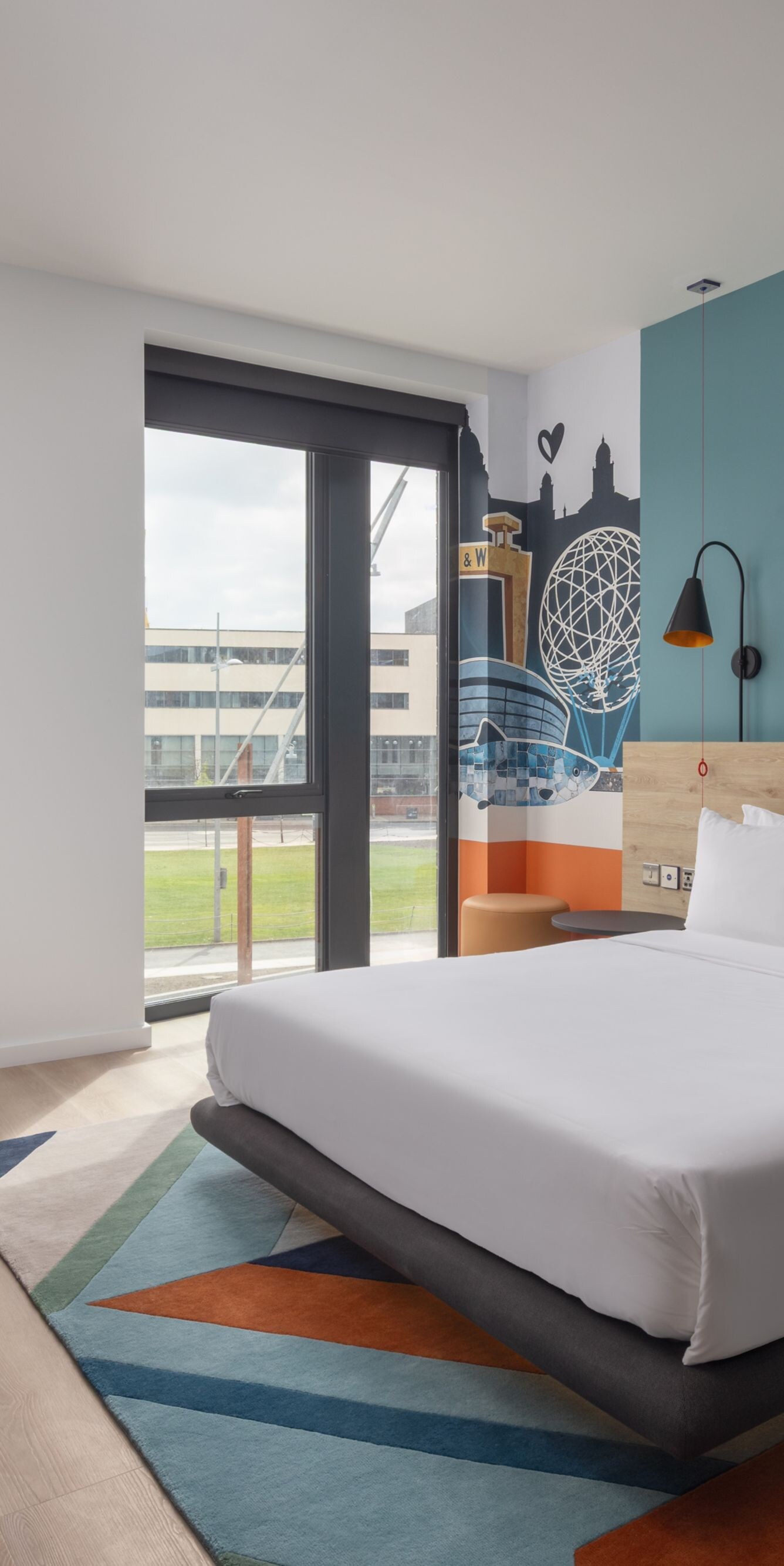 Modern room with bed, sofa, and city view