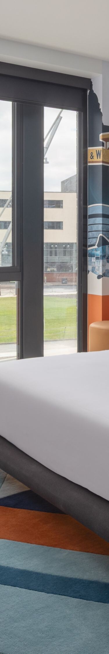 Modern room with bed, sofa, and city view
