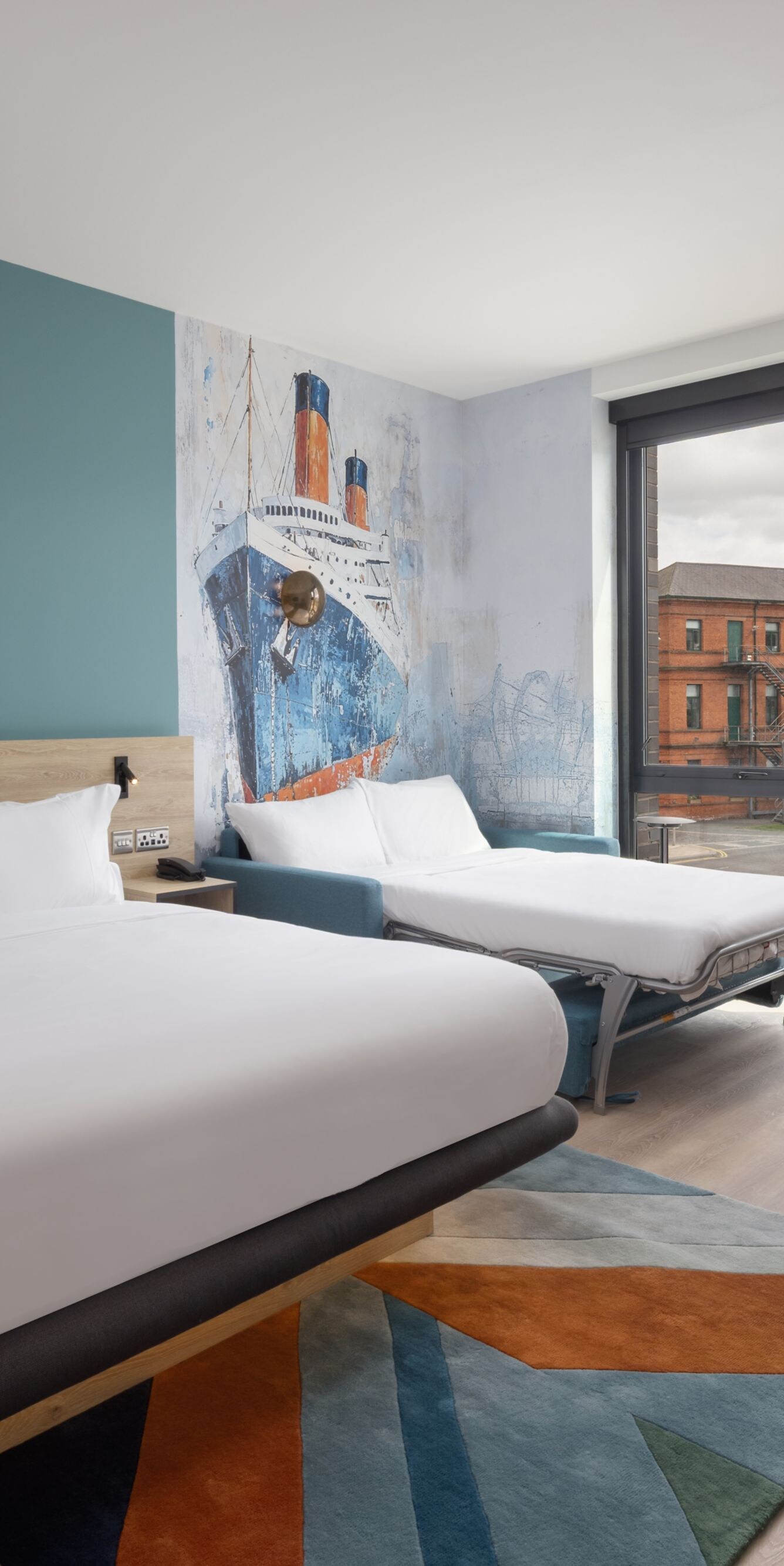 Modern room with bed, sink, and river view