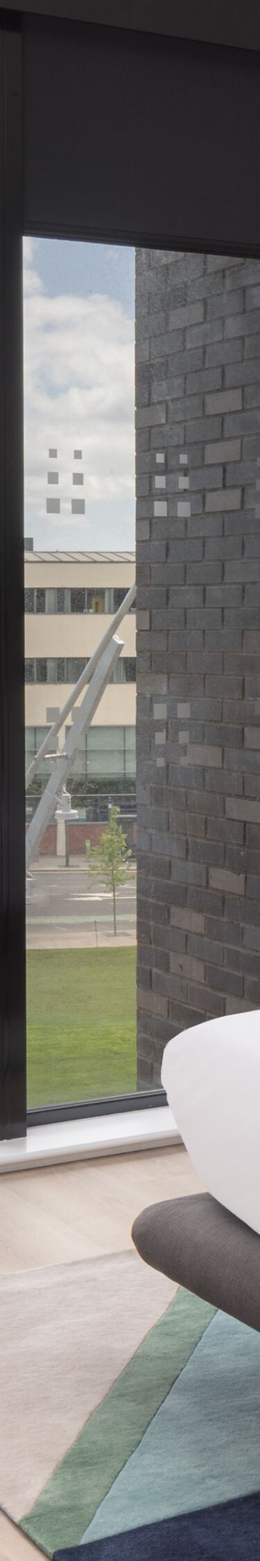 Hotel room with bed, chairs and city view