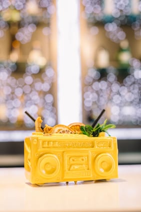 Cocktail served in boom box shaped glass 