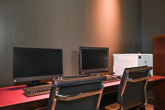 Two computers and two desk chairs