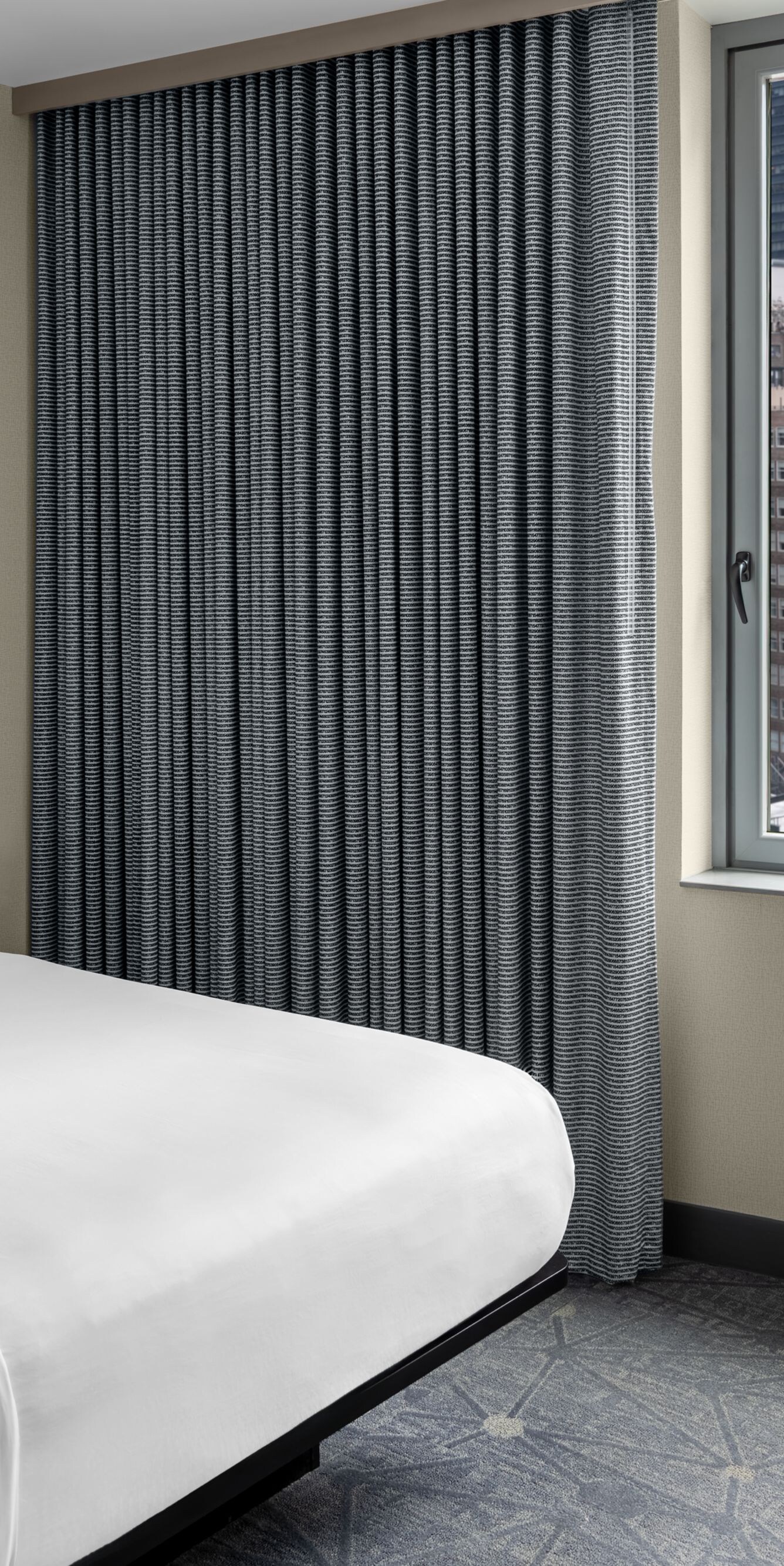 Guest room with bed and city view