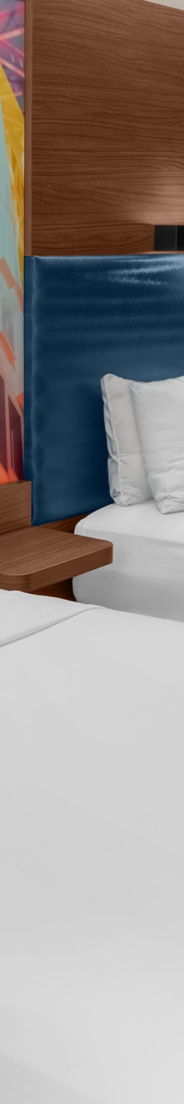 Double guest room with modern blue headboard