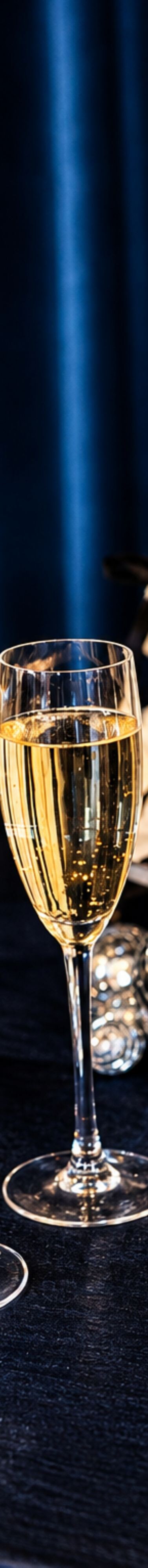 Champagne glasses beside wedding cake