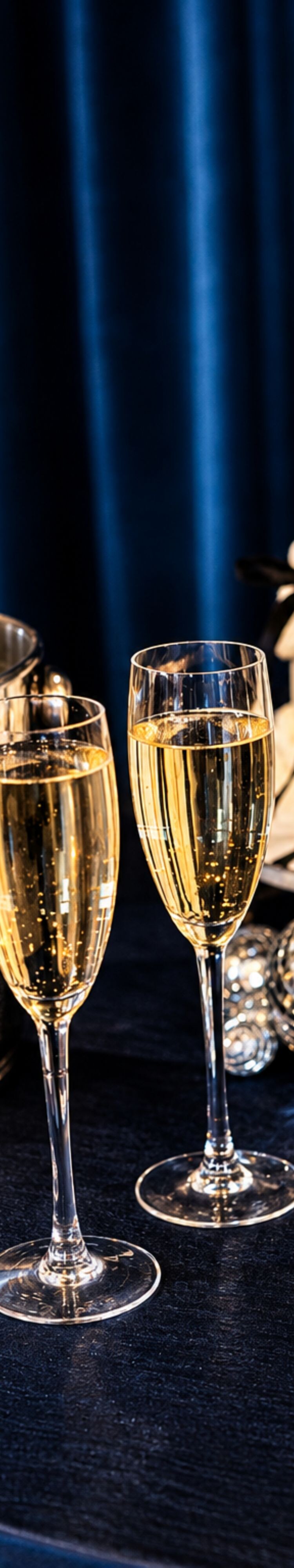 Champagne glasses beside wedding cake