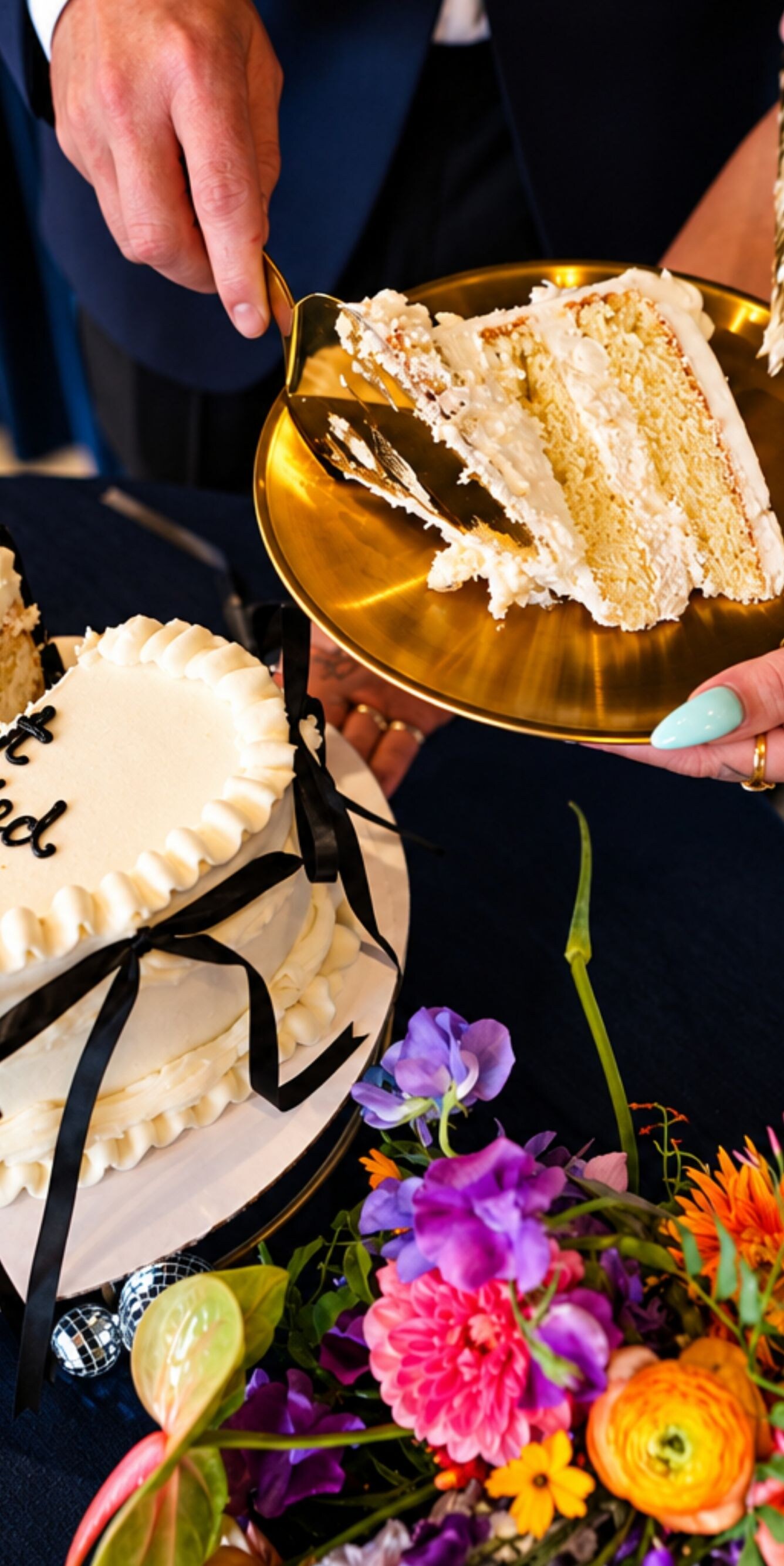 Couple serving heart-shaped wedding cake