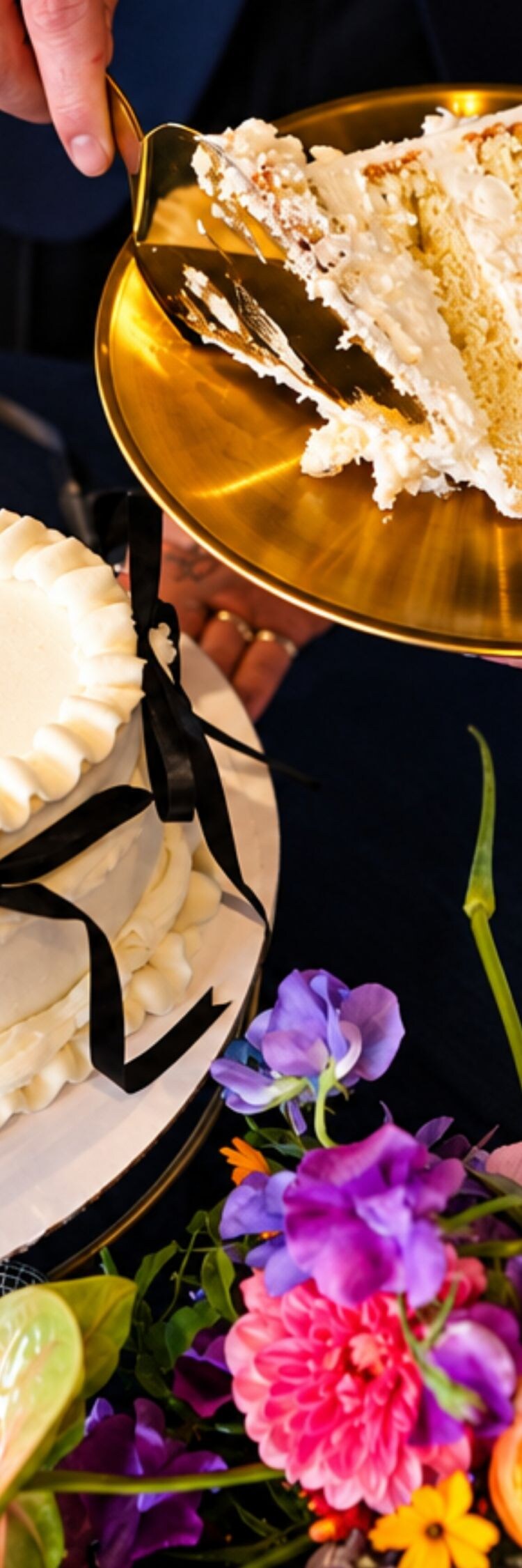 Couple serving heart-shaped wedding cake