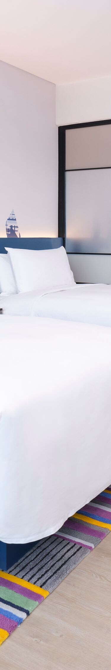 Guest room beds with sofa, table, TV