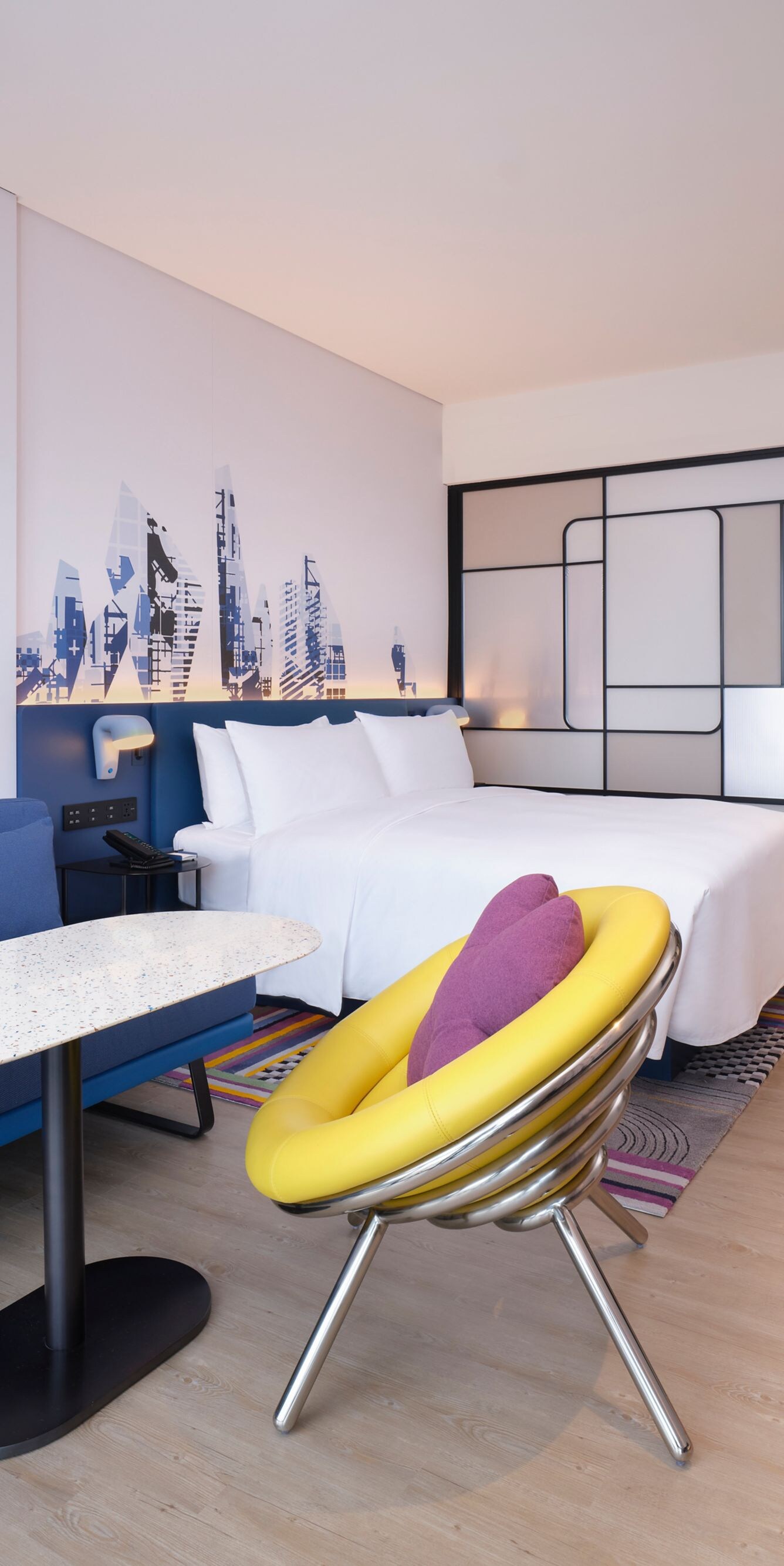 Guest room bed with chair, table, sofa TV