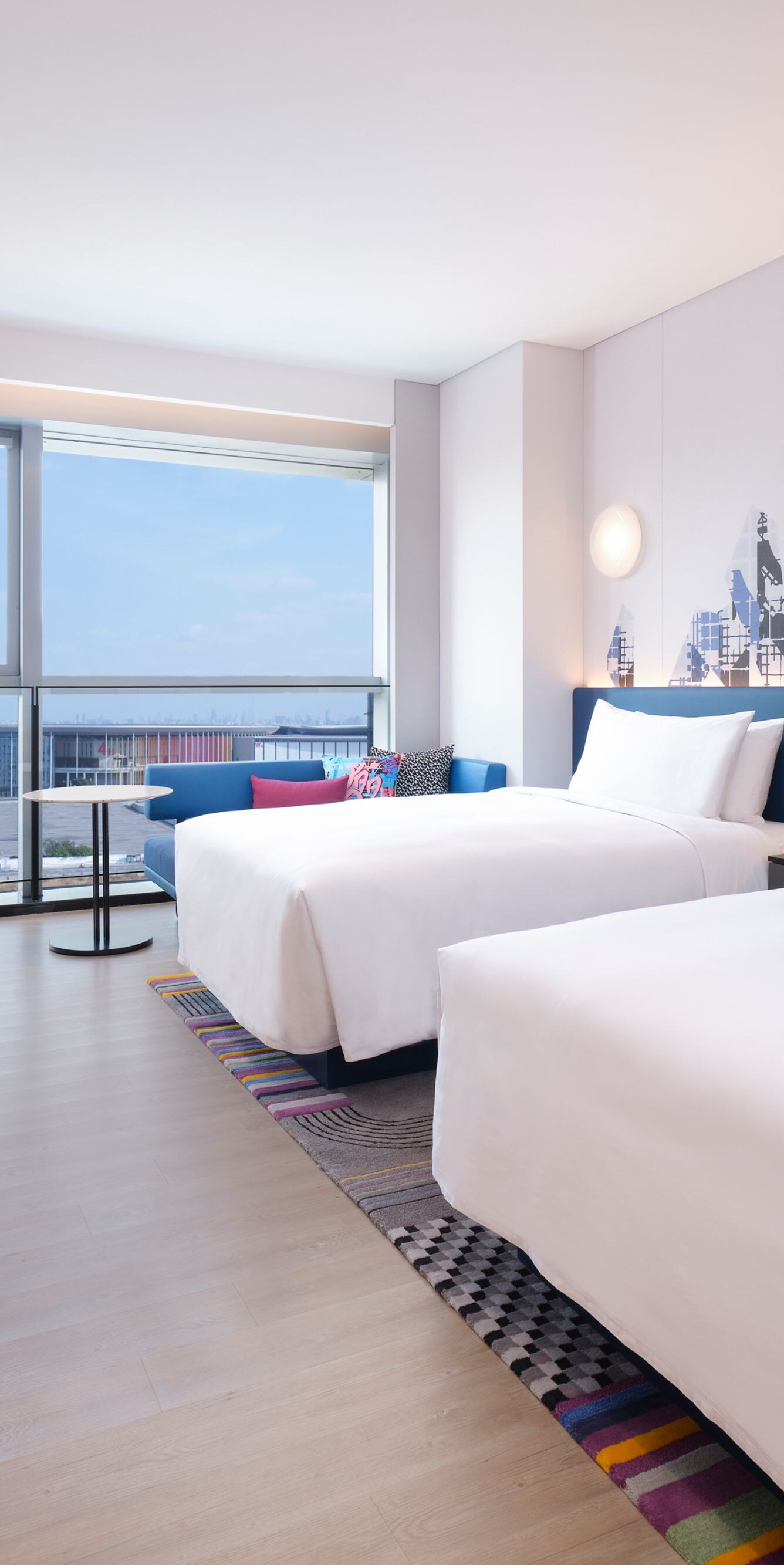 Guest room beds with chair, table, TV