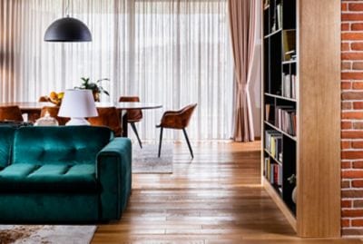 Modern interior apartment with green suede couch a