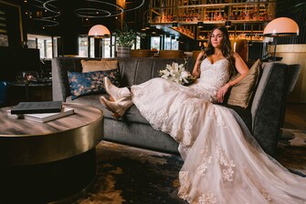 Bride sitting on couch in The Otis' lobby