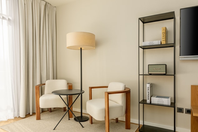 Junior Suite living room, chairs, lamp, bookshelf,