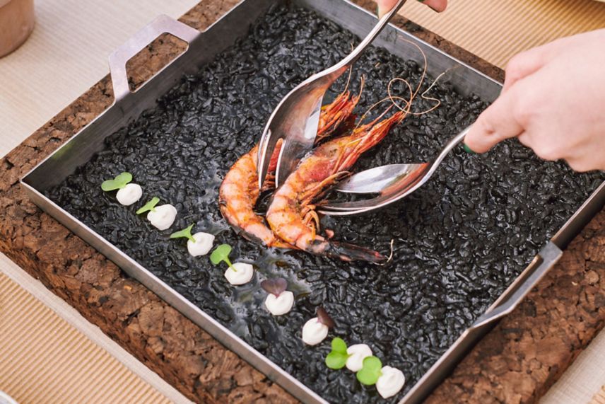 Black rice with shrimps served with a spoon