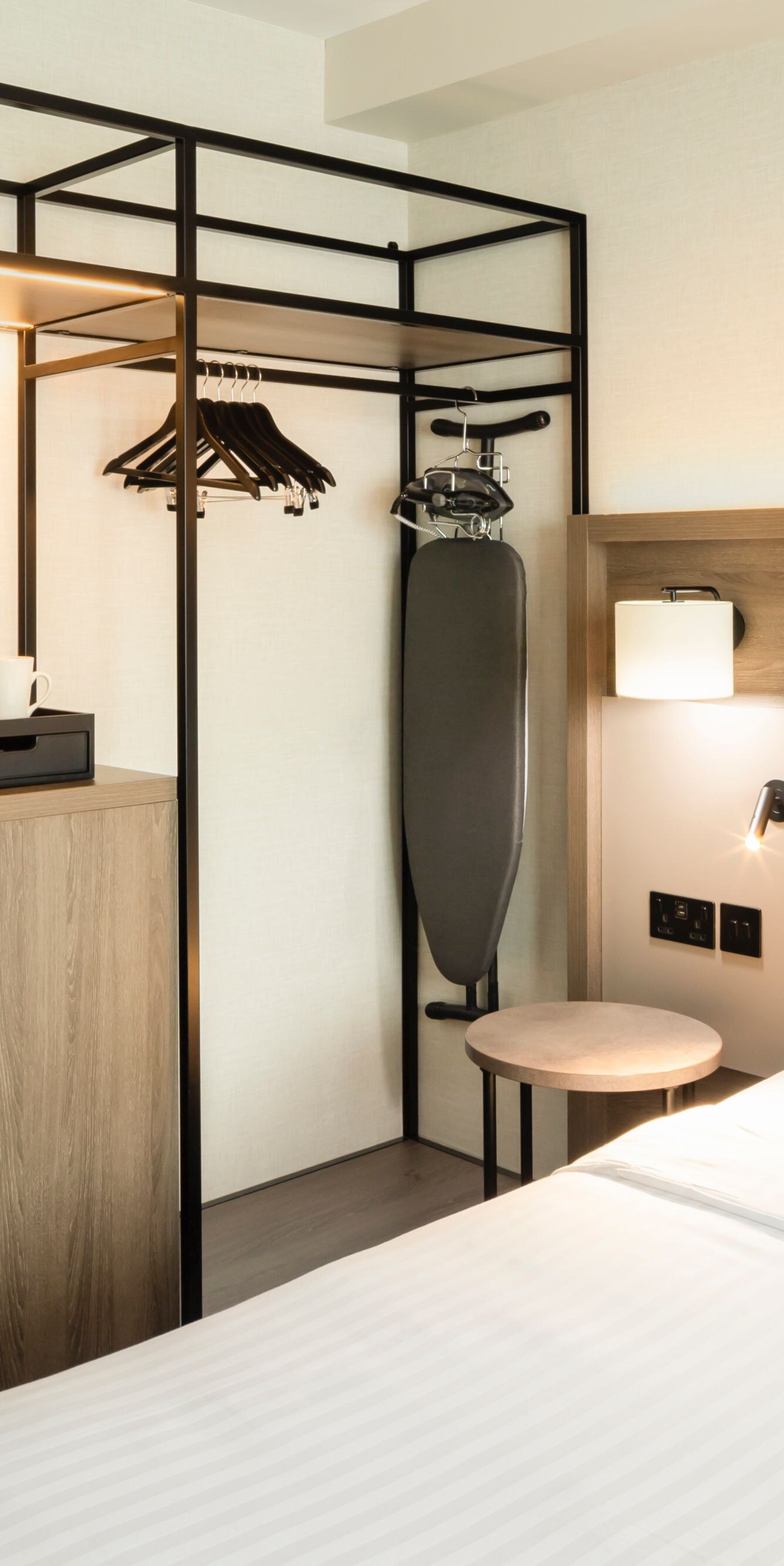 King bed in a warmly lit modern hotel room.