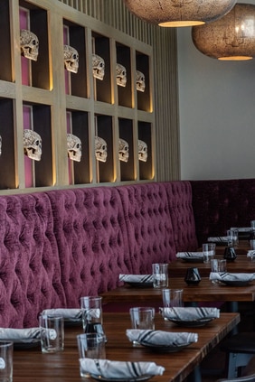 plush purple seating, place setting, skull decor