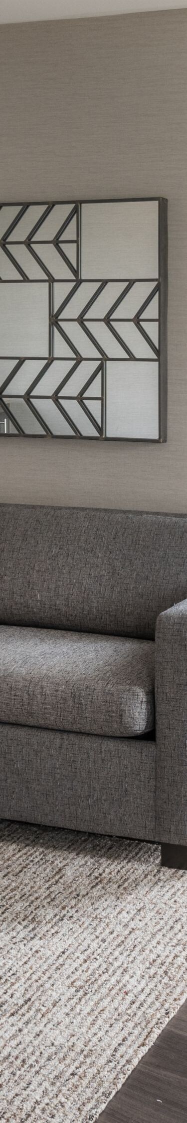 Living area with couch, desk and chair.