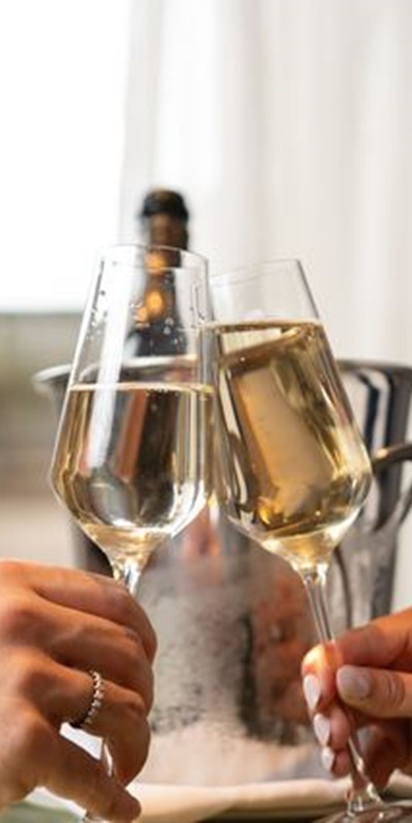 Two hands toasting with champagne flutes