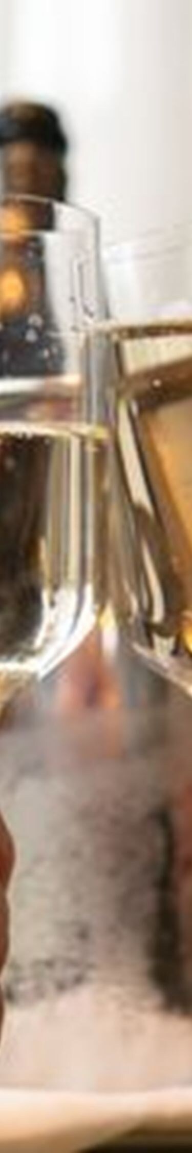 Two hands toasting with champagne flutes