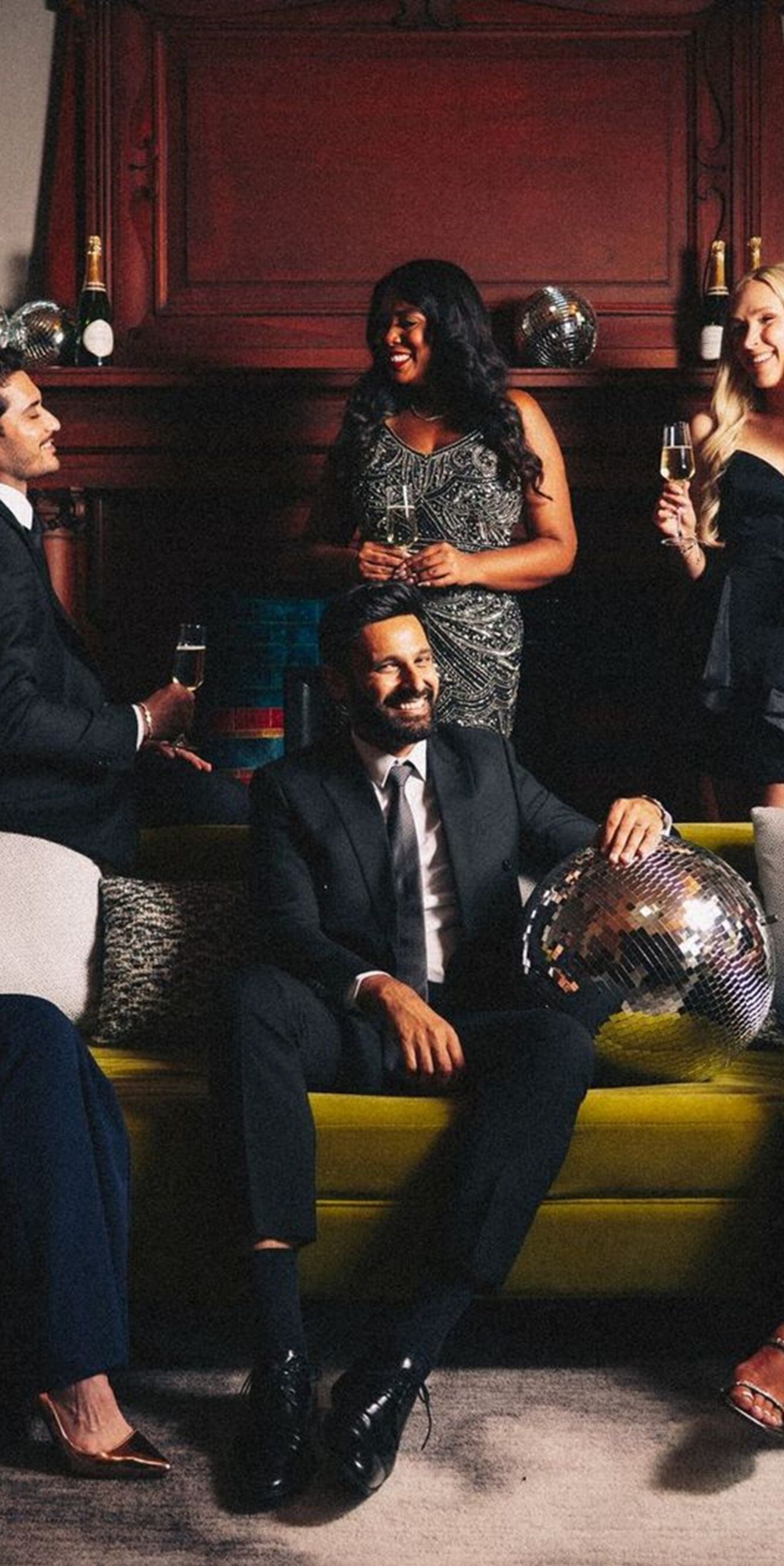 Group in formal attire with disco balls